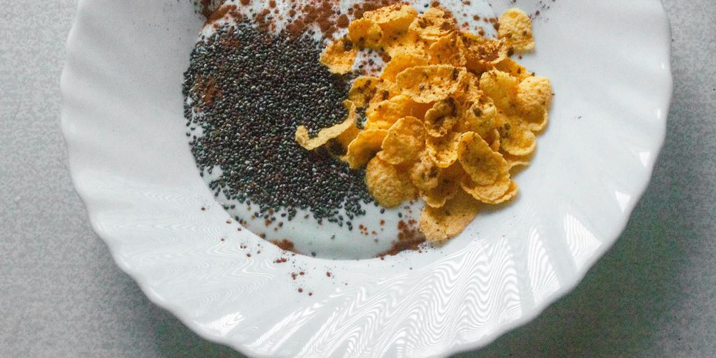a white plate topped with cereal and other foods